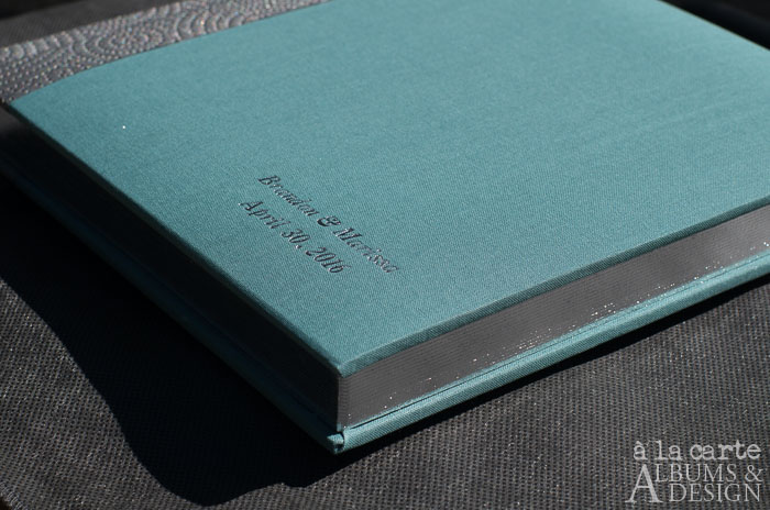 flush album in teal linen with sterling cirque spine, silver imprinting and page gilding, italic
